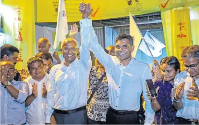  ?? AP ?? Ibrahim Mohamed Solih (left), and his running mate Faisal Naseem celebrate their victory in Male on Monday. —