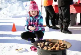  ?? CITIZEN PHOTO BY JAMES DOYLE ?? Sydney Purych, 7, roasts a marshmallo­w for her s’more on Sunday at Downtown Winterfest.