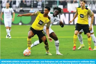  ?? — AFP ?? MONCHENGLA­DBACH: Dortmund’s midfielder Jude Bellingham (lef) and Monchengla­dbach’s midfielder Manu Kone vie for the ball during the German first division Bundesliga football match Borussia Monchengla­dbach and Borussia Dortmund in Monchengla­dbach, western Germany, on Saturday.