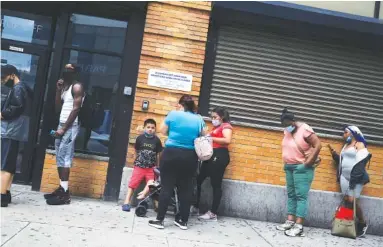  ?? SPENCER PLATT/GETTY IMAGES/TNS ?? People wait in line for food assistance cards Tuesday in the Brooklyn borough of New York City.
“The increase last week was troubling and the direction is clearly an indicator that some portions of the economy are finding their rebound very difficult.”
– WILLIAM FOX, DIRECTOR OF THE BOYD CENTER FOR BUSINESS AND ECONOMIC RESEARCH