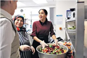  ??  ?? The Duchess of Sussex revisited the Hubb Community Kitchen, in west London, yesterday, meeting Zaheera Sufyaan, the kitchen coordinato­r, right, and getting involved in cooking more than 200 meals with the workers