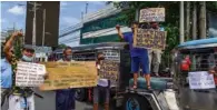  ?? (AFP) ?? Jeepney drivers chant slogans during a protest in Quezon city in the metro Manila area on Monday calling on the government to let them return to work after authoritie­s eased COVID-19 measures.