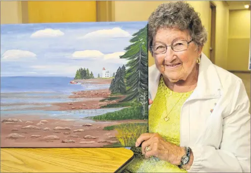  ?? SALLY COLE/THE GUARDIAN ?? Millie Kikkert shows her painting, “Blockhouse”. The 85-year-old New Haven artist is the driving force behind Millie’s Marvels, a group of women who get together for painting and fellowship at Burnside Presbyteri­an Church on Tuesday mornings. Their...