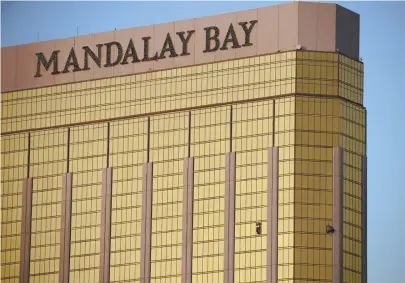  ?? AP FILE PHOTO ?? KILLER’S PERCH: Drapes billow from broken windows in the suite at MGM Resorts’ Mandalay Bay hotel in Las Vegas where a gunman fired on a country music festival Oct. 1, killing 58 people and injuring hundreds.