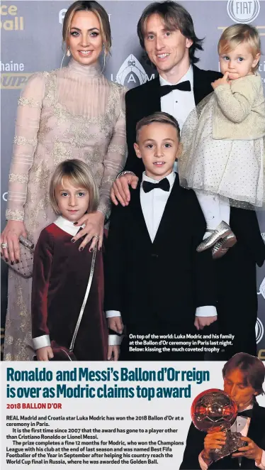  ??  ?? On top of the world: Luka Modric and his family at the Ballon d’Or ceremony in Paris last night. Below:kissingthe muchcovete­dtrophy