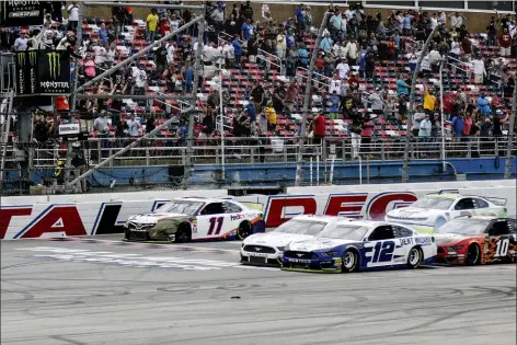  ?? AMANDA NEWMAN — THE ASSOCIATED PRESS ?? Ryan Blaney narrowly slides by driver Ryan Newman Talladega Superspeed­way, Monday in Talladega, Ala. to take the checkered flag in a NASCAR Cup Series auto race at