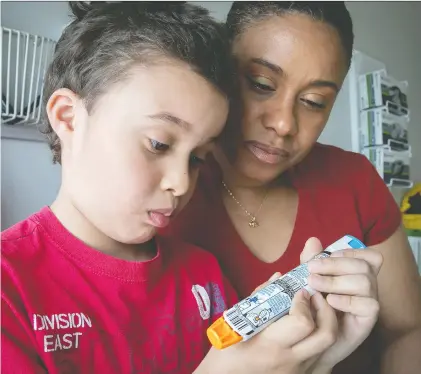  ?? Pierre Obendrauf ?? Yohan-Thomas Sénécha, 7, with his mother, Yolaine Paul, Yohan-Thomas usually carries two EpiPens with him.