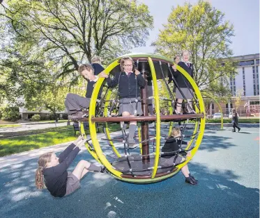  ??  ?? Grade 5 students from Christ Church Cathedral School check out the playground on the former tent-city site on the Victoria courthouse grounds. The students helped design the park, which opened Thursday.