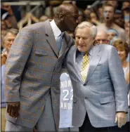  ?? File photo/AP ?? Former North Carolina player Michael Jordan (left) gives his former coach Dean Smith a kiss during halftime of a college basketball game between North Carolina and Wake Forest in Chapel Hill, N.C., on Feb. 10, 2007.