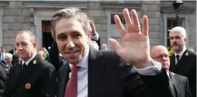  ?? ?? The new Prime Minister of Ireland Simon Harris waves at the media and the crowd following his election outside Leinster House in Dublin, Ireland. Harris was selected after the previous Prime Minister Leo Varadkar resigned. Photo: Peter Morrison/AP