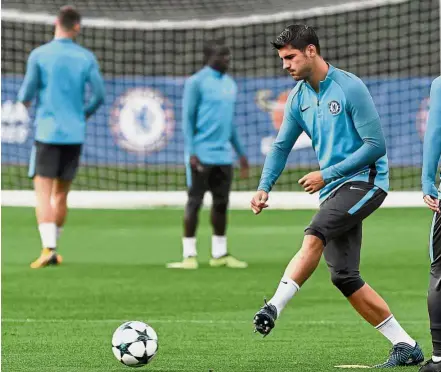  ??  ?? Hot homecoming: Alvaro Morata warming up during Chelsea’s training session in London yesterday. — Reuters