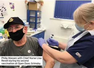  ??  ?? Philip Massen with Chief Nurse Lisa Revell during his second vaccinatio­n at Open Door, Grimsby.