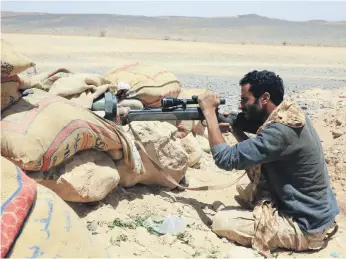  ?? AFP ?? A pro-government fighter keeps watch in the central Yemeni province of Marib