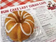  ?? STAFF PHOTO BY ANNE BRALY ?? Don’t need a whole cake? The Rum Cake Lady Cuban Cafe sells mini rum cakes, just the right size for one or two.