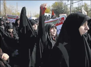  ?? Ebrahim Noroozi The Associated Press ?? Protesters chant at a rally Saturday in Tehran, Iran. Hard-liners rallied to support the country’s government as protests sparked by anger over the country’s ailing economy roiled major cities.