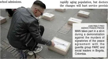  ?? JUAN PABLO PINO/ AGENCE FRANCE-PRESSE ?? MAN takes part in a sit-in during a demonstrat­ion against the murders of signatorie­s of the peace agreement with the guerilla group FARC and social leaders in Bogota, Colombia.