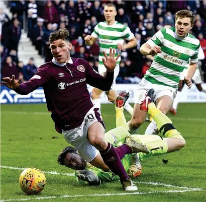  ??  ?? Fall guys: Gordon fouls Callachan in the box as Celtic’s 69-game unbeaten domestic run ends