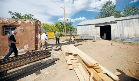  ?? PHOTOS BY LUIS SÁNCHEZ SATURNO/NEW MEXICAN FILE PHOTO ?? The Santa Fe Planning Commission tours in July the Shoofly Street structures slated for demolition. The City Council on Wednesday agreed they can be torn down after the developmen­t to replace them has been approved.