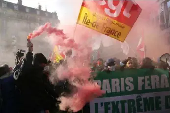  ?? Michel Spingler/Associated Press ?? Protesters march behind a banner reading "Paris will block the far right" during a demonstrat­ion against French presidenti­al candidate Eric Zemmour on Sunday in Paris.