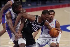  ?? CARLOS OSORIO — THE ASSOCIATED PRESS ?? Sacramento Kings forward Harrison Barnes (40) is fouled by Detroit Pistons center Isaiah Stewart, left, next to Pistons guard Dennis Smith Jr. (0) on Friday in Detroit.