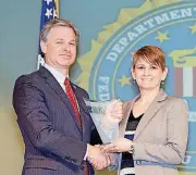  ?? [PHOTO PROVIDED] ?? FBI Director Christophe­r Wray presents the 2017 Director’s Community Leadership Award to Rabbi Vered Harris, spiritual leader of Temple B’nai Israel, in an April 20 ceremony in Washington, D.C.