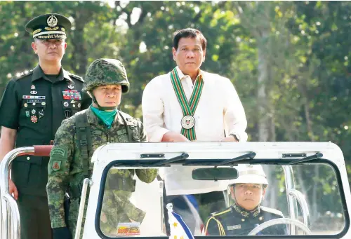  ??  ?? President Rodrigo Duterte reviews the troops with Army Chief Lt. Gen. Glorioso Miranda during the 120th anniversar­y celebratio­ns of the Philippine Army on Tuesday. (AP)