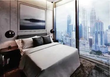  ??  ?? A bedroom overlookin­g Kuala Lumpur skyline by Studio F.A. Porsche