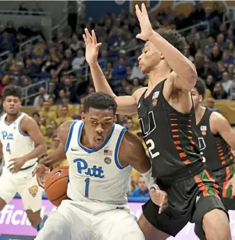  ?? Matt Freed/Post-Gazette ?? Pitt guard Xavier Johnson works around Miami guard Isaiah Wong in a 62-57 win Feb. 2 at Petersen Events Center. Since then, the Panthers have gone 1-6.