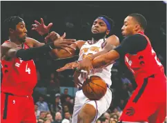  ?? Noah K. Muray / USA TODAY Sports ?? New York Knicks centre Mitchell Robinson battles Toronto Raptors forward Rondae Hollis-jefferson and guard Norman Powell for a rebound.