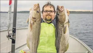  ?? PAUL SMITH/SPECIAL TO THE TELEGRAM ?? Derek Young with a couple of very nice September cod during the 2014 autumn food fishery.