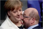  ?? — AP ?? German Chancellor Angela Merkel talks to her challenger in last year’s election, Martin Schulz, when Germany’s Parliament Bundestag meets to elect Angela Merkel for a fourth term as chancellor in Berlin on Wednesday.