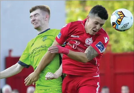  ??  ?? Mark Doyle loses out in this aerial duel against Shelbourne on Friday night.