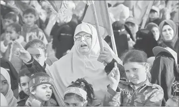  ??  ?? Palestinia­ns take part in a rally marking the 29th anniversar­y of the creation of the Islamist movement Hamas in Rafah in the southern Gaza Strip. — AFP photo