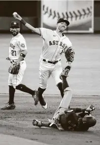  ?? Karen Warren / Staff photograph­er ?? Astros shortstop Carlos Correa throws to first to complete a second-inning double play. The defense helped starter Lance McCullers Jr. escape jams in each of the first two innings.