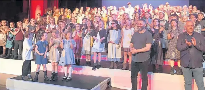  ?? REBECCA EMILY LLOYD ?? Actor Michael Sheen joined Roger Burnell, the artistic director of Bridgend Youth Theatre, on stage at the Grand Pavilion in Porthcawl following the performanc­e of Annie