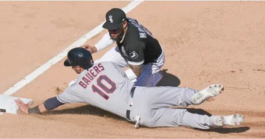  ?? NUCCIO DINUZZO/GETTY IMAGES ?? Yoan Moncada tags out Indians first baseman Jake Bauers at third base in the fourth inning Saturday at Guaranteed Rate Field.
