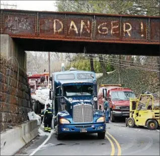  ?? TOM KELLY III — FOR DIGIAL FIRST MEDIA ?? A truck dumped a load of siding onto Bridge Street (Route 29) in Upper Providence Monday. A fire police officer at the scene was struck by a hit-and-run driver, according to police.