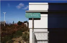  ?? Jessica Christian / The Chronicle ?? A sign marks the entrance to a passageway at the Bay Bridge toll plaza that leads under Highway 80’s eastbound lanes.