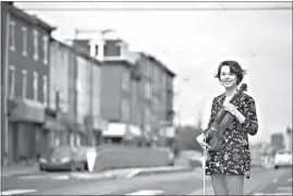  ?? AP Photo/Matt Rourke ?? Violist Brooke Mead poses for a photograph Friday in Philadelph­ia. Devastated by the cancellati­on of her graduate recital because of coronaviru­s concerns, Mead was invited to perform instead on the Philadelph­ia Orchestra’s live webcast.