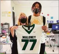  ?? Jeff Jacobs / Hearst Connecticu­t Media / ?? Maloney’s Daejon Nixon, right, poses with Yvonne Royce as part of the football team’s jersey swap to honor the school’s teachers.