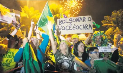  ?? Picture: AFP ?? OUR MAN. Supporters of far-right presidenti­al candidate Jair Bolsonaro celebrate in front of his house in Rio de Janeiro, Brazil, after he won Brazil’s presidenti­al election on Sunday.