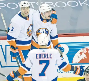  ?? AP ?? TWICE AS NICE: Kieffer Bellows (top right) celebrates his one of his two goals with defenseman Adam Pelech and right wing Jordan Eberle during the third period of Saturday’s victory in Newark.