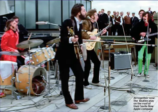  ?? ?? All together now: The Beatles play on the roof of their Savile Row Apple company