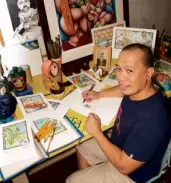  ??  ?? DANIEL Palma Tayona at work. His original illustrati­ons are mounted in an exhibit at Canvas gallery in QC.