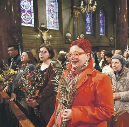  ?? ?? People attend a service to celebrate Palm Sunday at St. Joseph Cathedral, in Bucharest, Romania. PHOTO: AFP