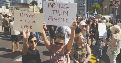  ?? (Janis Laizans/Reuters) ?? DEMONSTRAT­ORS IN Tel Aviv call for the return of loved ones who were taken as hostages into Gaza by Hamas terrorists.