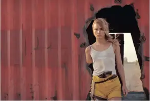  ?? Picture: NEON ?? FEASTED UPON: Arlen (Suki Waterhouse) walks among boxcars in