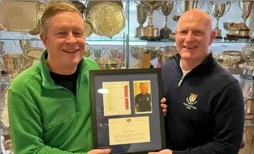  ?? ?? Chris Almond, left, receives a framed scorecard, picture and written declaratio­n commemorat­ing his record-busting gross 65 from 2023 captain Mark Broadhurst