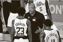  ?? Kim Klement-Pool / Getty Images ?? Clippers coach Doc Rivers, center, gave an impassione­d speech after the latest shooting of a Black man by police officers.