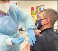  ?? Contribute­d photo ?? Nurse Maureen Singer administer­s the Moderna COVID vaccine to Danbury fire Lt. Mark Miguel on Dec. 30. The Danbury Health Department administer­ed 300 COVID vaccines over the course of a week to health care workers and first responders.